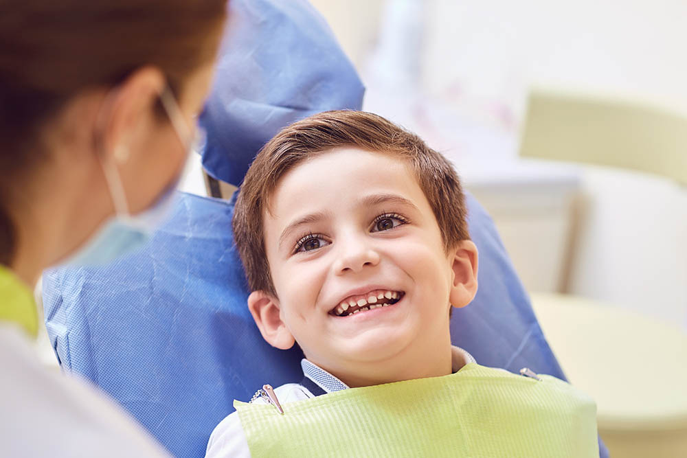 A child with a dentist in a dental office. Dental treatment in a children's clinic.