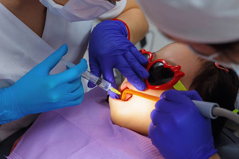 girl in a dentist seat having fillings performed